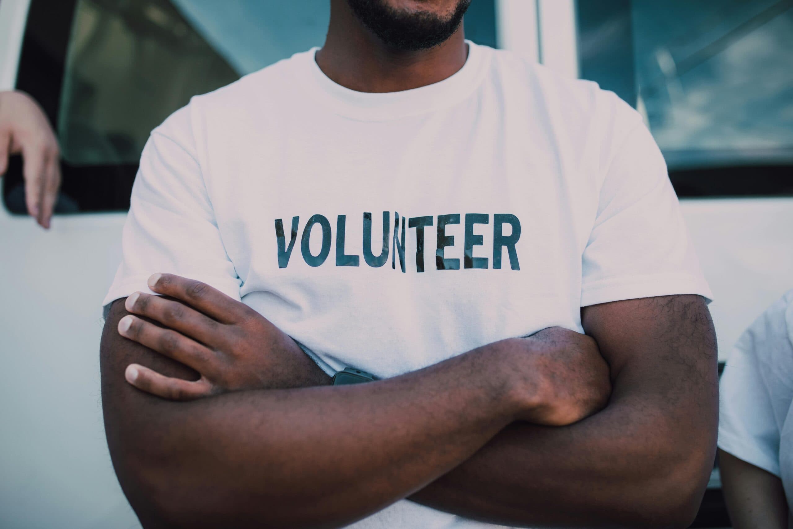 Volunteer wearing red volunteer shirt ready to help the community